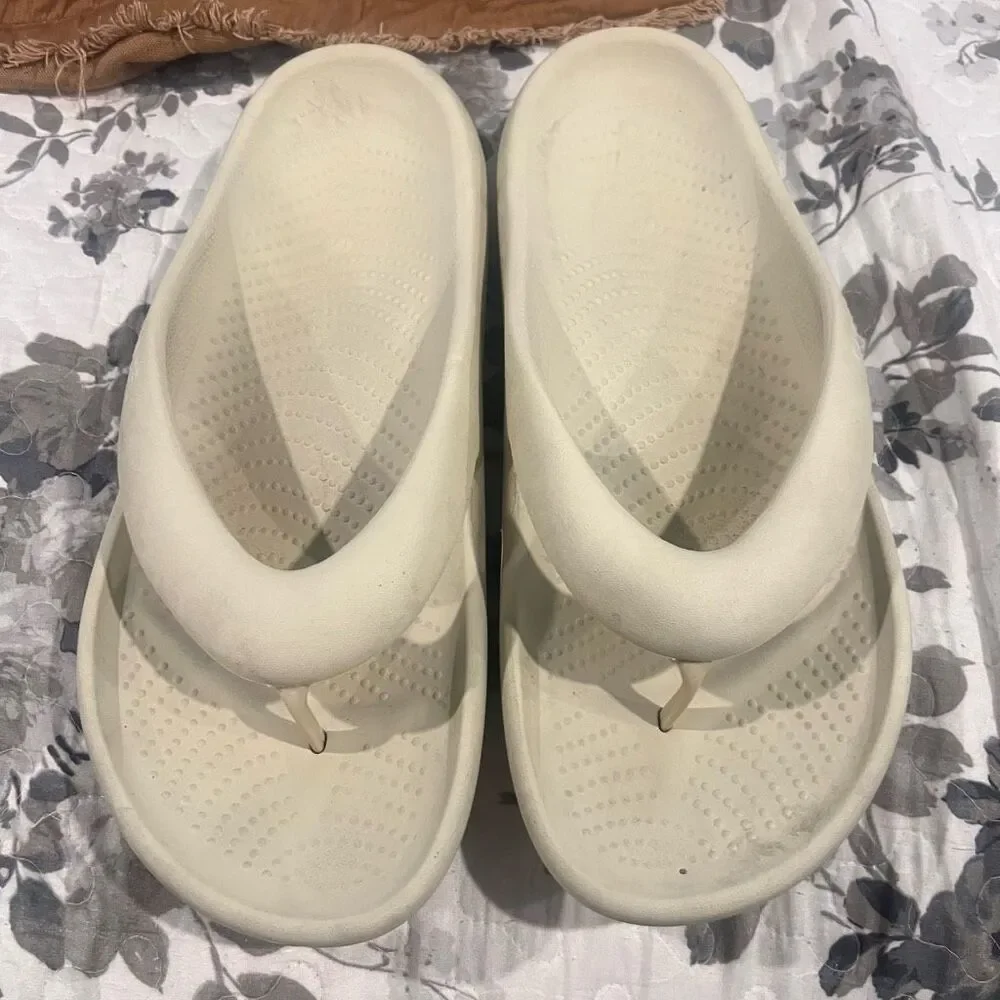 Crocs Mellow Flip sandals feature a thick, comfortable footbed designed for reco